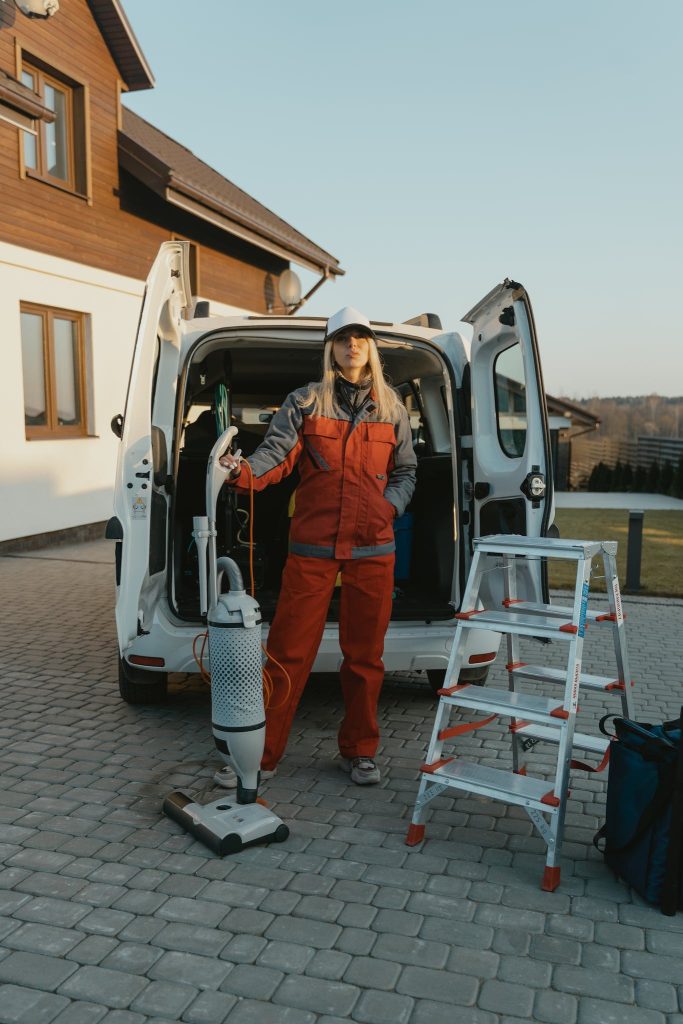 Woman Holding a White Vacuum